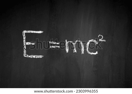 Theory of relativity. physical formula. Black school board. E mc2 Royalty-Free Stock Photo #2303996355