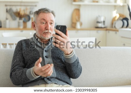 Happy middle aged senior man talk on video call with friends family. Laughing mature old senior grandfather having fun speaking with grown up children online. Older generation modern tech usage Royalty-Free Stock Photo #2303998305