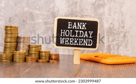 Business abbreviation BHW Bank Holiday Weekend, written on yellow paper attached with pins on gray fabric wall, available copy space.