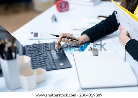 young woman working on computer at desk in office close up banner design