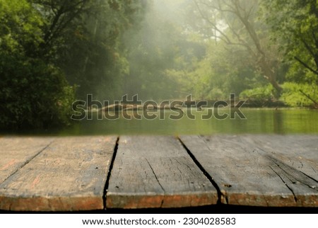 Empty wooden surface against  lagoon the forest  background , display podium for product mockups 3d trade show display advertising, Natural blurred defocused background 