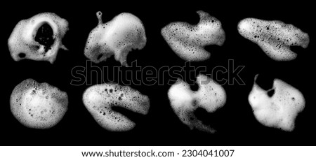 Top view, liquid white foam from soap or shampoo, or shower gel. Abstract bubbles. isolated on a black background  Royalty-Free Stock Photo #2304041007