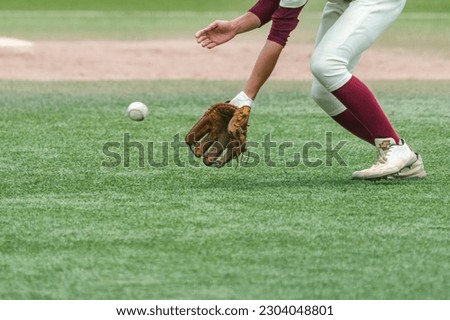 Second infielder catching a batted ball during a baseball game.