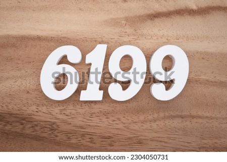 White number 6199 on a brown and light brown wooden background.
