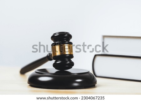 Closeup wooden gavel hammer and law book in empty law firm or white lawyer office background as justice and legal system by lawyer and judge, Legal authority and fairness in trial concept. equility Royalty-Free Stock Photo #2304067235
