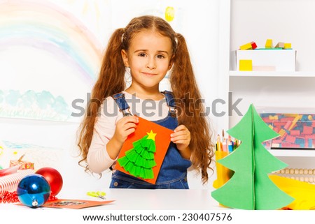 Beautiful girl holding handmade carton card