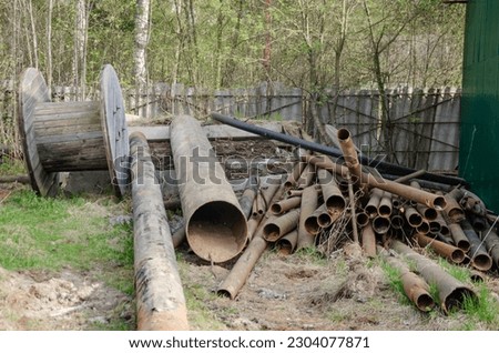 The pipes are stacked for discharge, a pile of garbage from iron pipes. High quality photo