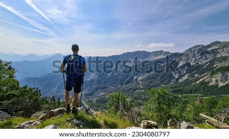 Man admiring the scenic view near  Mittagskogel on the mountain peaks in the Karawanks, Carinthia, Austria. Borders between Austria, Slovenia, Italy. Julian Alps, Triglav National Park. Mystical hills Royalty-Free Stock Photo #2304080797