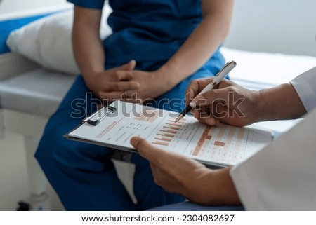 Prostate cancer specialist and testicular patient discuss testicular cancer test report Testicular and Prostate Cancer Infertility, EPAD - European Prostate Cancer Awareness Day Royalty-Free Stock Photo #2304082697