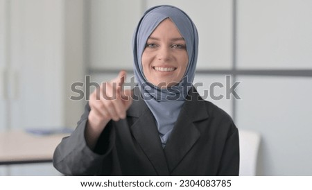 Portrait of Muslim Businesswoman Pointing at Camera