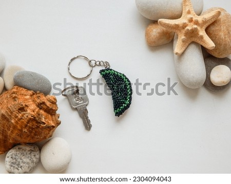 Bead colorful key chain and stones. Bright key chain and sea conch