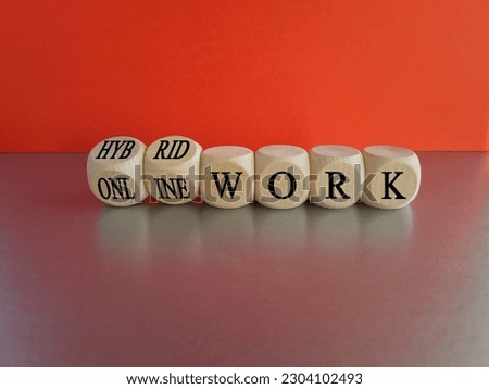Hybrid or online work symbol. Turned cubes and changes words 'online work' to 'hybrid work'. Beautiful red background, grey table. Business, hybrid or online working concept, copy space.