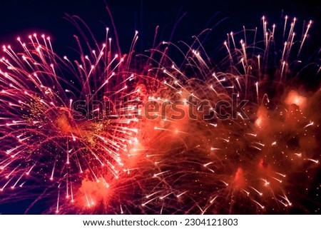 Amazing holiday colorful fireworks display on celebration, showing. Festive wallpaper concept. Full frame bright firework with sparks, colored stars and nebula on black night sky, comets. Copy space