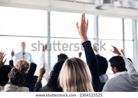 Conference, convention and business people with hands for a question, vote or volunteering. Corporate event, meeting and hand raised in a training seminar for questions, voting or audience opinion Royalty-Free Stock Photo #2304125525