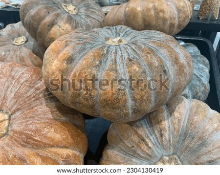 A picture of a pile of green pumpkins