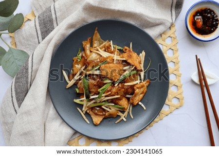Chow fun with beef - Stir fried flat noodle with bean spout and scallion, famous Chinese food at top view  Royalty-Free Stock Photo #2304141065