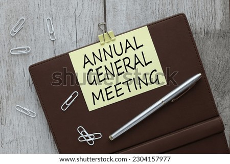 AGM - annual general meeting, business concept. text on yellow sticky note.website promotion concept mockup.