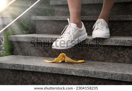 Adult young male guy worker under food fruit skin fit sole hurry urban town city work house move forward idea concept. Closeup view boy jogger office trap job risky fault outdoor travel risk error fun Royalty-Free Stock Photo #2304158235