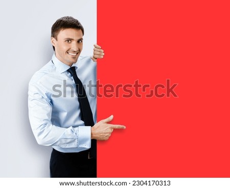 Image of business man, employee, professional in confident shirt wear. Businessman stand behind, hang over, show point finger empty red color banner signboard. Isolated grey gray background