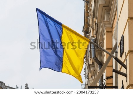 Waving flag of Ukraine on an old building, a symbol of the state