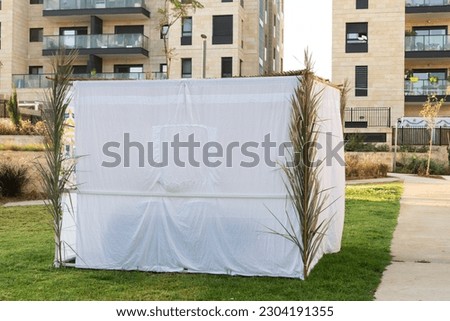 A sukkah, a temporary structure used as a home duringf the observance of Sukkot, made from cotton walls  and metal frame.  Royalty-Free Stock Photo #2304191355