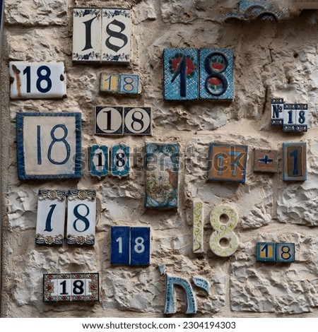 Multiple ceramic number signs featuring "18," which in Judaism is equated with the Hebrew word "chai" which means life. 