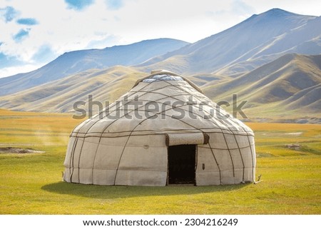 Yurt. National old house of the peoples of Kyrgyzstan and Asian countries. national housing. Yurts on the background of green meadows and highlands. Yurt camp for tourists. Royalty-Free Stock Photo #2304216249