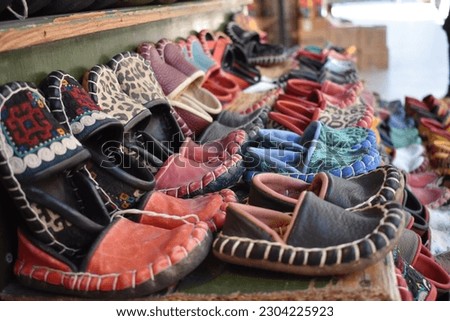 handmade traditional shoes from ottoman empire is shown. These are the chidish shoes used in ancient turkey. Vintage footwear from  history is shown in this pictures which have diffrent colours. 
