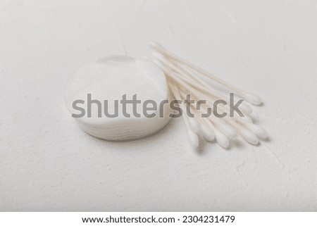 Cotton buds on a textured cement background. Cotton swab on a white background. Sticks for hygiene of the nose and ears. Plastic cotton swabs. Cotton wool. Space for text.Space for copy.