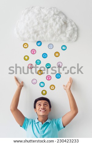 Young man storing applications in cloud storage