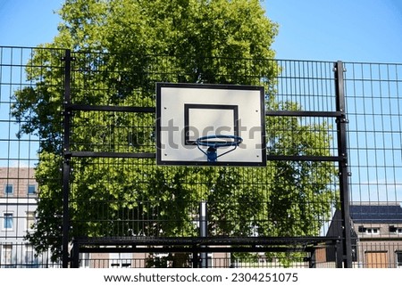Basketball hoop on an outside sports ground.