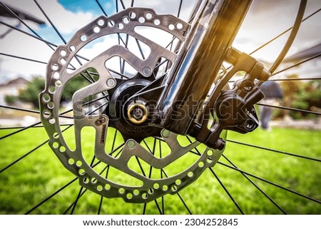 Modern bicycle disc brake rotors, close up view on bicycle hydraulic disc brakes Royalty-Free Stock Photo #2304252845