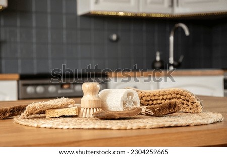 Border made of various cleaning brushes and sponges of various natural materials in home kitchen. Coconut, sisal, bamboo, wood fibers, sea sponge, loofah. Zero waste lifestyle concept. Royalty-Free Stock Photo #2304259665