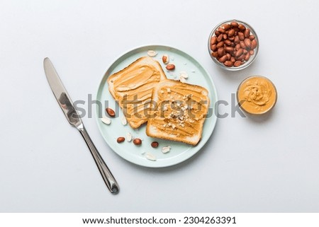 Peanut butter sandwiches or toasts on light table background.Breakfast. Vegetarian food. American cuisine top view vith copy space. Royalty-Free Stock Photo #2304263391