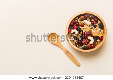 Cooking a wholesome breakfast. Granola with Various dried fruits and nuts in a bowl. The concept of a healthy dessert. Flat lay, top view with copy space. Royalty-Free Stock Photo #2304263407