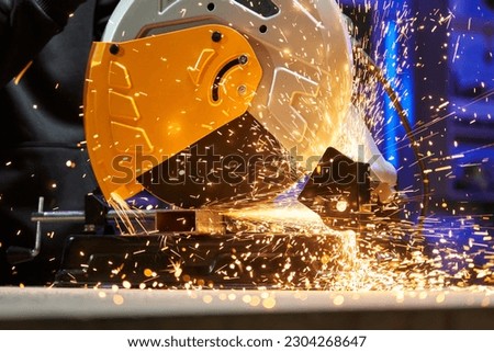 close-up disc cutting machine cuts a metal profile. a lot of sparks fly out from under the protective cover Royalty-Free Stock Photo #2304268647