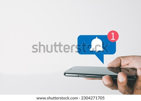 Reminder,digital marketing,business concept.,Close up of hand using smartphone with Bell Notification icon on white background with copyspace suitable for internet,application,e-mail,technology idea. Royalty-Free Stock Photo #2304271705