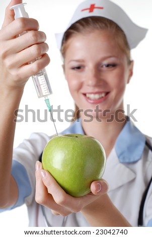 nurse with syringe make injection in green apple