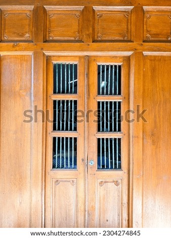 Old windows made of solid teak wood