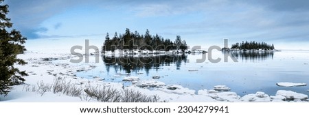 Beautiful winter panorama along the shores of the St. Lawrence River during winter Royalty-Free Stock Photo #2304279941