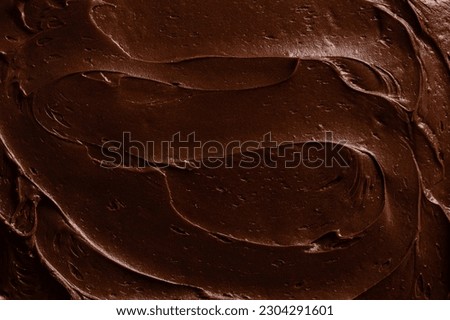 Chocolate icing on a chocolate fudge cake close up.  Royalty-Free Stock Photo #2304291601