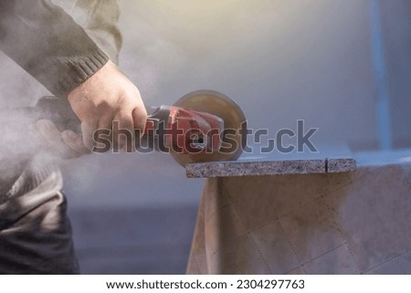 Close up of industrial tool, grinder cutting piece of stone. Royalty-Free Stock Photo #2304297763