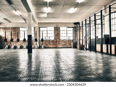 Empty gym, health club and floor for equipment, training and health in open room for fitness, workout or sport. Modern interior, space and background for sports, exercise and healthy lifestyle