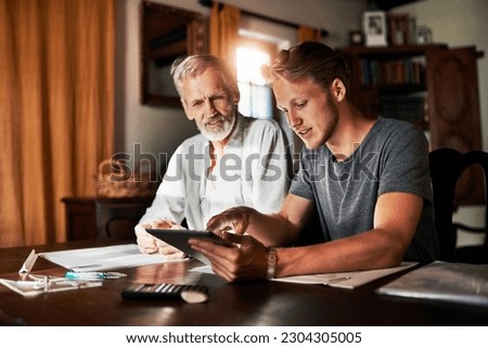 Tablet, investment or retirement with a father and son in their home for savings, budget or finance planning. Accounting, money or insurance with a man helping his senior pensioner parent in the home Royalty-Free Stock Photo #2304305005