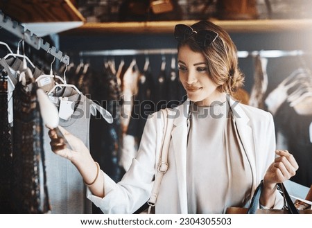 Shopping, fashion and woman with a sale, boutique and discount items with retail, client and luxury. Female person, customer and shopper with price tag, store and outfit choice with clothes selection Royalty-Free Stock Photo #2304305503