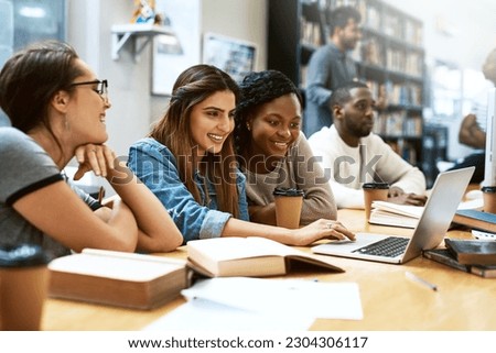 Women, students in library with laptop and studying for exam or research for project with education. Young female people in study group, search internet on pc and learning on university campus Royalty-Free Stock Photo #2304306117