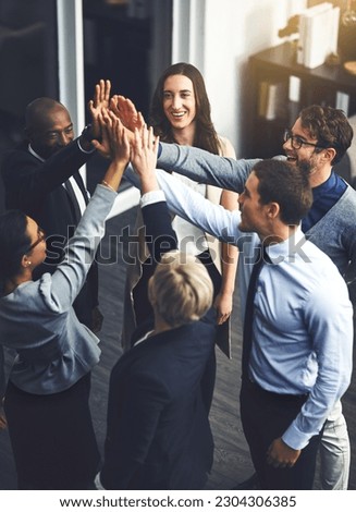 Teamwork, high five and support with business people in office for success, winner and motivation. Collaboration, diversity and community with group of employees for solidarity, target and goals Royalty-Free Stock Photo #2304306385