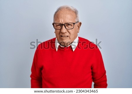 Senior man with grey hair standing over isolated background skeptic and nervous, frowning upset because of problem. negative person.  Royalty-Free Stock Photo #2304343465