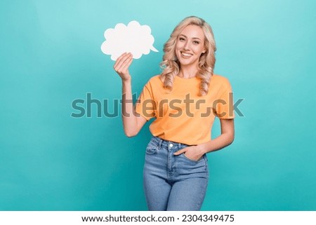 Photo of cheerful positive nice girl with wavy hairstyle yellow t-shirt arm in pocket hold mind cloud isolated on teal color background
