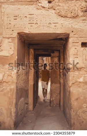 young male traveler visits Karnak temple in Luxor, Egypt Royalty-Free Stock Photo #2304355879